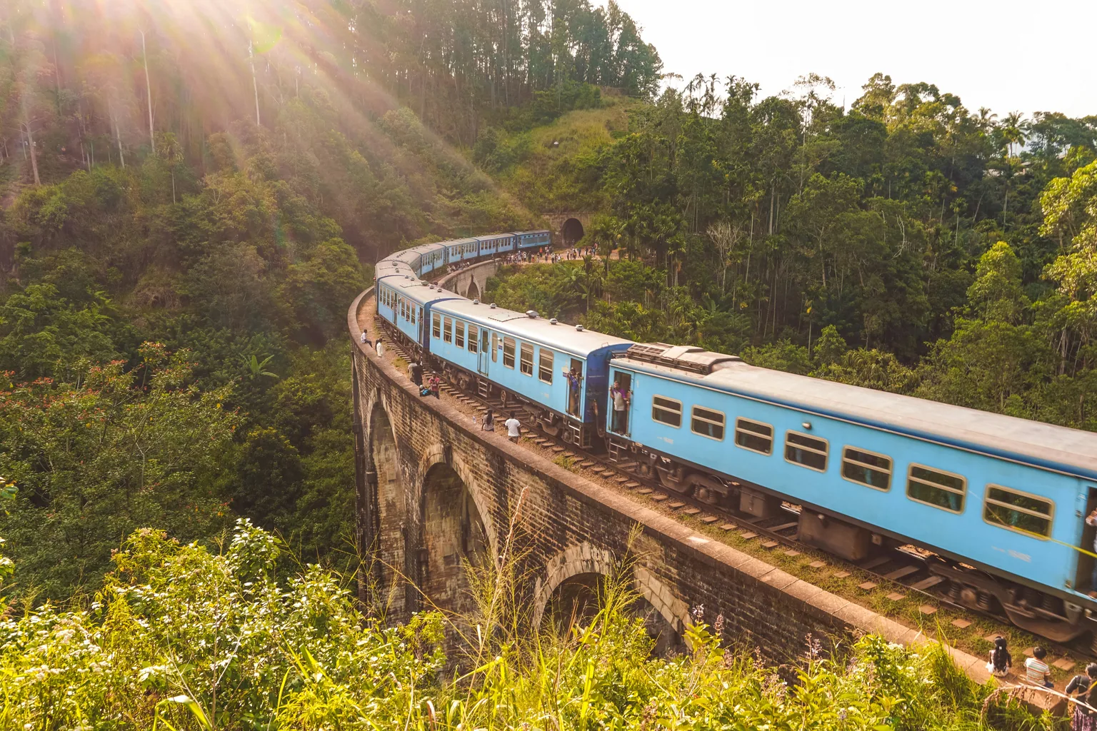 The Nine Arch Bridge at Ella with the hill-country train crossing above dense tea plantations